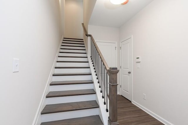 stairs with baseboards and wood finished floors