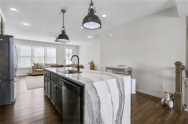 kitchen featuring pendant lighting, a ceiling fan, a sink, dark wood-style floors, and appliances with stainless steel finishes