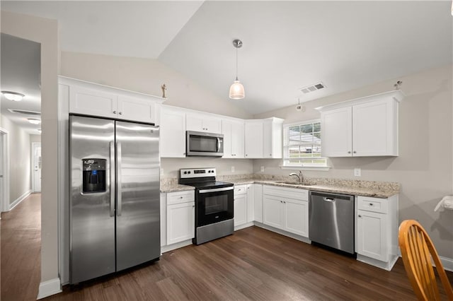 1672 Meadow Lark Ln, Gainesville, GA 30501 - kitchen with appliances with stainless steel finishes, a sink, vaulted ceiling, dark wood-type flooring, and white cabinetry