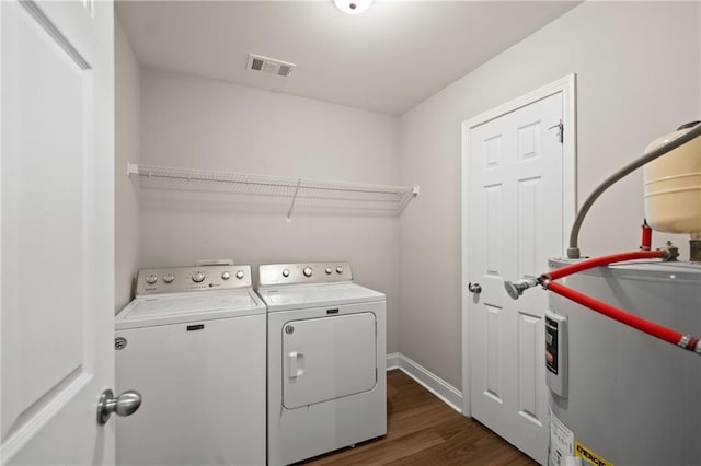 1672 Meadow Lark Ln, Gainesville, GA 30501 - laundry room featuring water heater, washer and clothes dryer, dark wood-style floors, and baseboards
