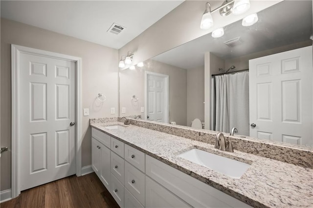 1672 Meadow Lark Ln, Gainesville, GA 30501 - bathroom with double vanity, wood finished floors, baseboards, and curtained shower