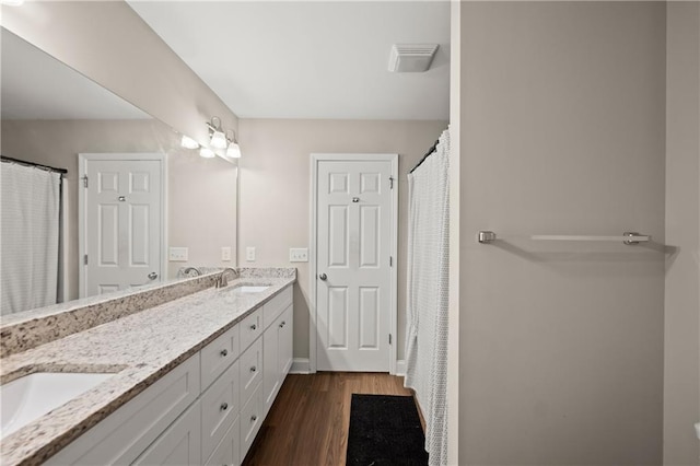 1672 Meadow Lark Ln, Gainesville, GA 30501 - bathroom featuring double vanity and wood finished floors