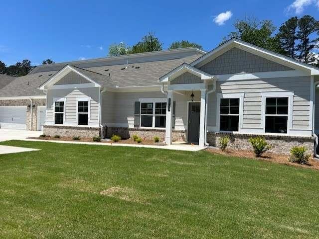 craftsman-style home with a front yard