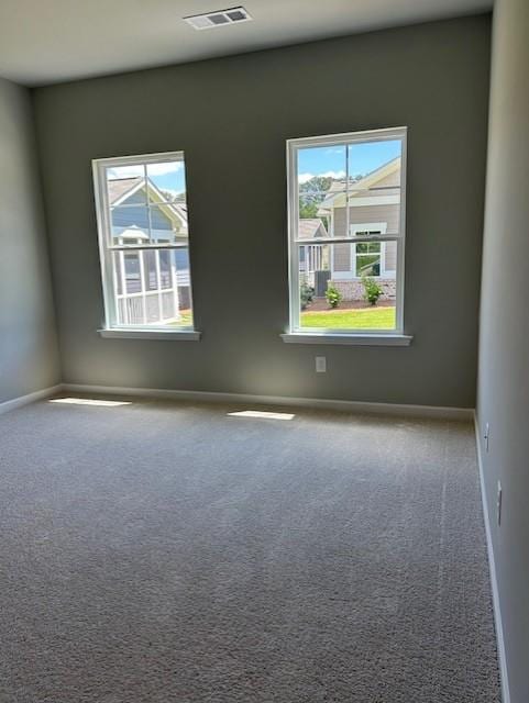 unfurnished room featuring carpet flooring and baseboards