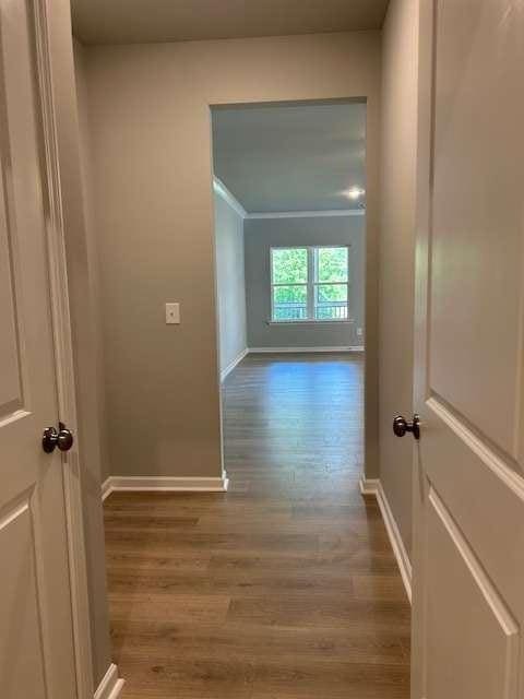 hall with wood finished floors and baseboards