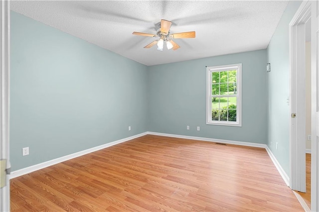 6752 Stringer Rd, Clermont, GA 30527 - spare room with a ceiling fan, light wood-type flooring, baseboards, and a textured ceiling