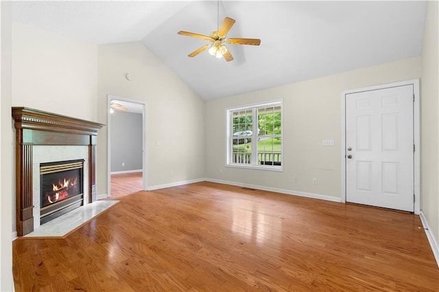 6752 Stringer Rd, Clermont, GA 30527 - unfurnished living room featuring a ceiling fan, a premium fireplace, vaulted ceiling, wood finished floors, and baseboards