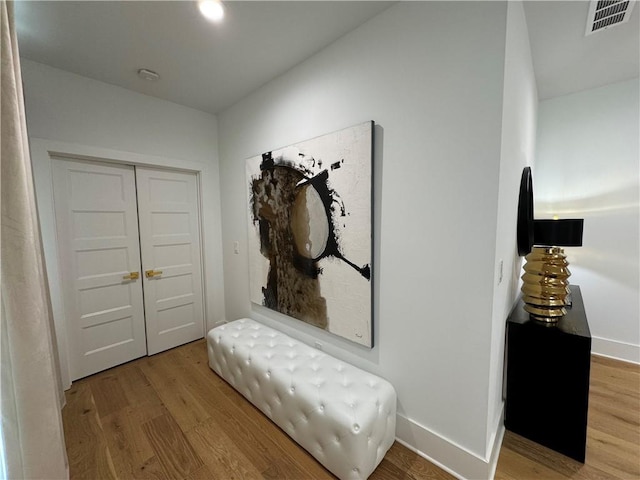 corridor with hardwood / wood-style flooring