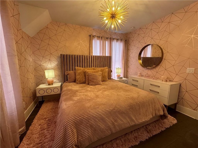 bedroom featuring a notable chandelier and lofted ceiling