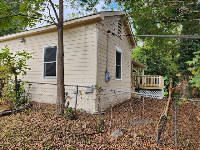 view of side of property featuring a wooden deck