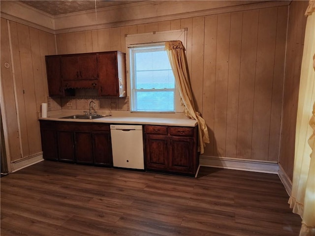 kitchen with dark hardwood / wood-style flooring, white dishwasher, wood walls, and sink