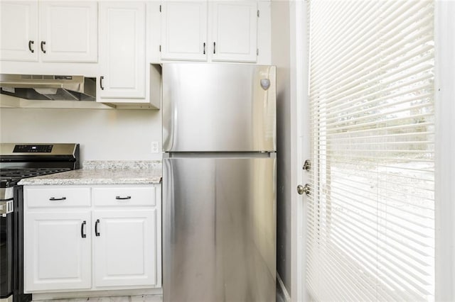1381 Benteen Way SE, Atlanta, GA 30315 - kitchen featuring stainless steel appliances, under cabinet range hood, white cabinets, and light stone countertops