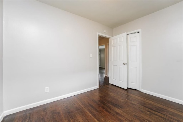 1381 Benteen Way SE, Atlanta, GA 30315 - unfurnished bedroom with baseboards, dark wood-type flooring, and a closet