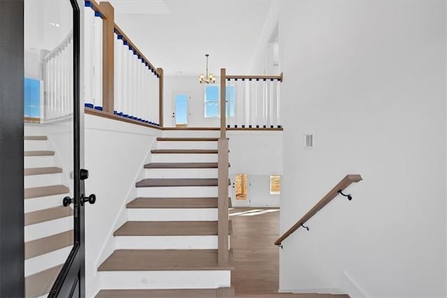 19 Bridgemill Dr, Douglasville, GA 30134 - staircase featuring a chandelier and wood finished floors