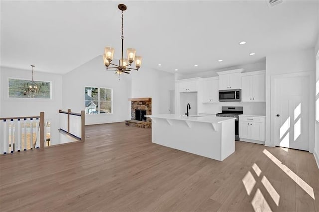 19 Bridgemill Dr, Douglasville, GA 30134 - kitchen featuring stainless steel appliances, a chandelier, light wood finished floors, white cabinetry, and recessed lighting