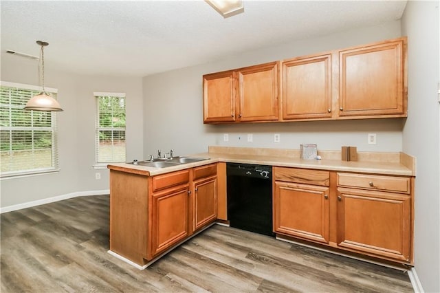 155 Oak Terrace Dr, Covington, GA 30016 - kitchen with dishwasher, a sink, wood finished floors, a peninsula, and a textured ceiling