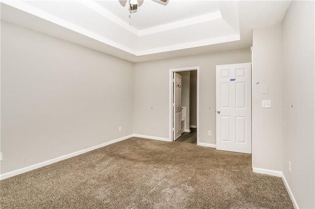 155 Oak Terrace Dr, Covington, GA 30016 - unfurnished bedroom featuring a raised ceiling, carpet flooring, baseboards, and ceiling fan