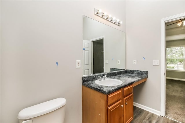 155 Oak Terrace Dr, Covington, GA 30016 - bathroom with toilet, vanity, baseboards, and wood finished floors