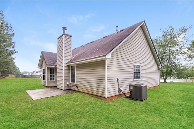 155 Oak Terrace Dr, Covington, GA 30016 - back of house featuring central AC, a patio, a chimney, and a shingled roof