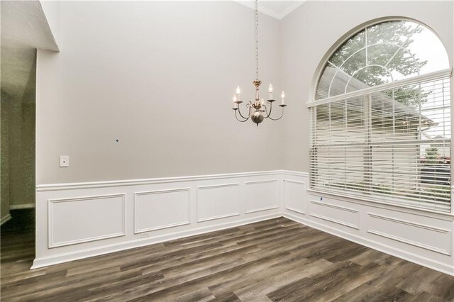 155 Oak Terrace Dr, Covington, GA 30016 - unfurnished dining area featuring ornamental molding, a chandelier, dark wood-style flooring, a wainscoted wall, and a decorative wall