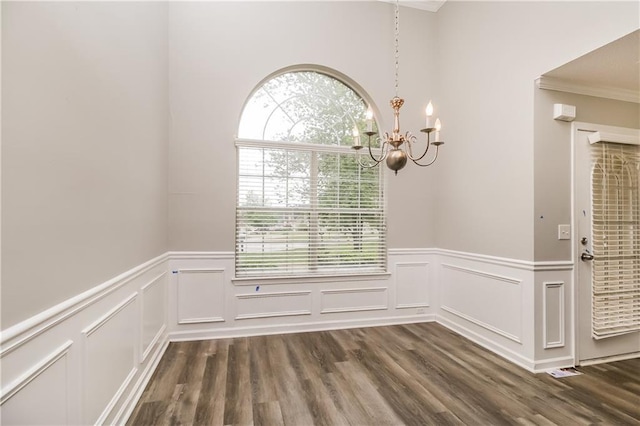 155 Oak Terrace Dr, Covington, GA 30016 - unfurnished dining area with a chandelier, dark wood-style floors, wainscoting, a decorative wall, and ornamental molding