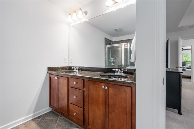 bathroom featuring vanity, walk in shower, and tile patterned flooring