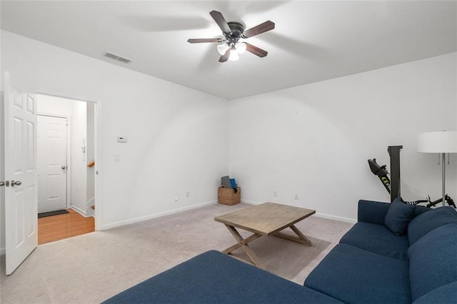 carpeted living room featuring ceiling fan