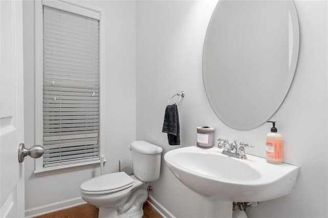 bathroom with toilet, hardwood / wood-style flooring, and sink