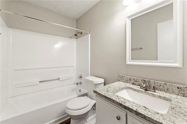 full bathroom with vanity, toilet, a textured ceiling, and bathing tub / shower combination