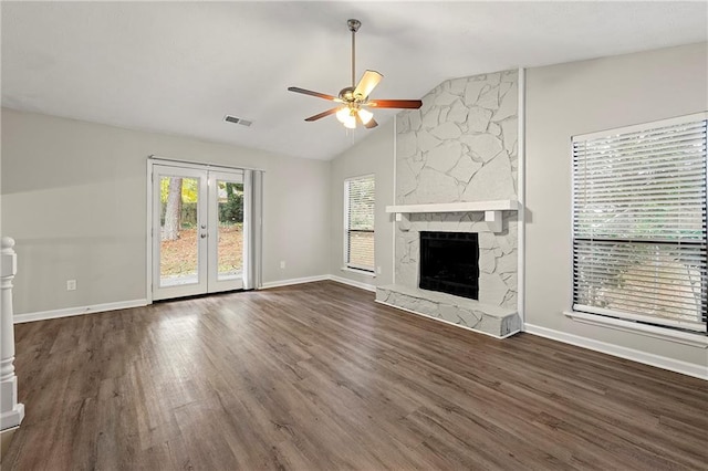 unfurnished living room with a fireplace, lofted ceiling, dark hardwood / wood-style floors, and ceiling fan