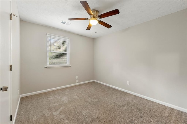 carpeted empty room with a textured ceiling and ceiling fan