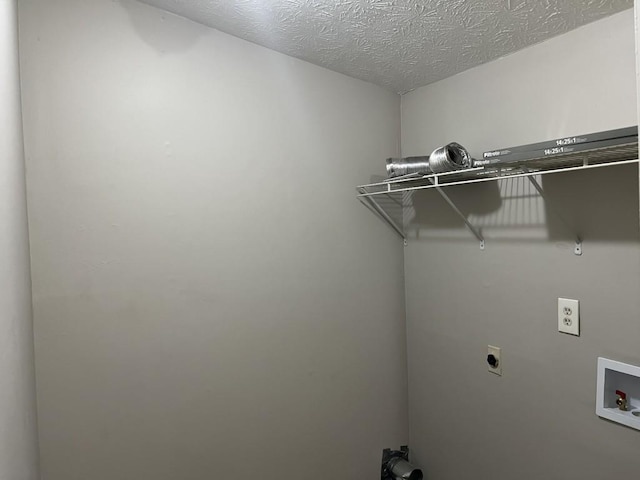 laundry area featuring electric dryer hookup, a textured ceiling, and hookup for a washing machine