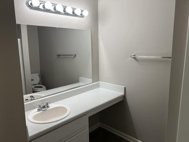 bathroom featuring vanity and toilet