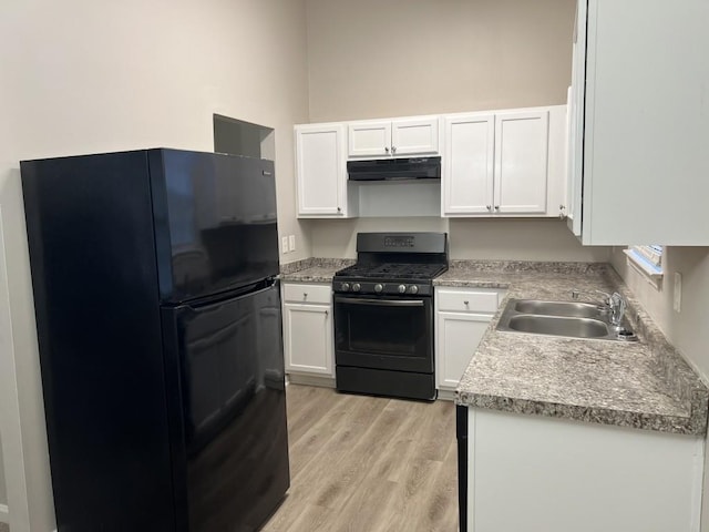 kitchen with sink, white cabinets, black appliances, and light hardwood / wood-style floors