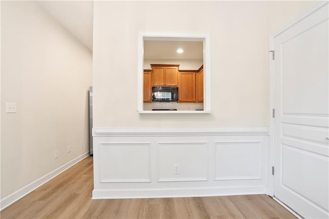 4130 Stonecypher Rd, Suwanee, GA 30024 - kitchen featuring black microwave, brown cabinets, light wood-style floors, light countertops, and recessed lighting