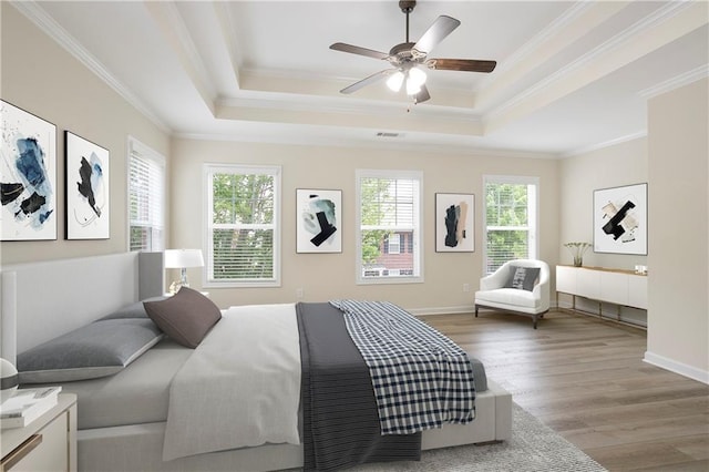 4130 Stonecypher Rd, Suwanee, GA 30024 - bedroom featuring wood finished floors, a tray ceiling, ornamental molding, and a ceiling fan