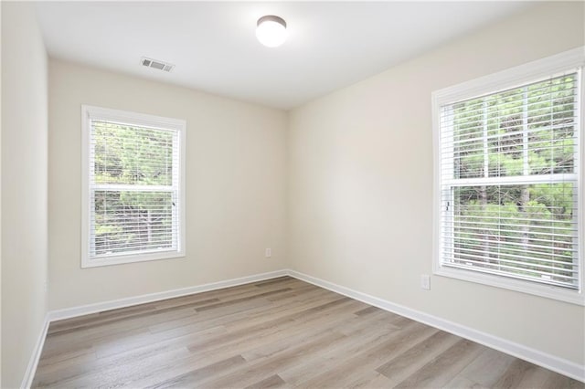 4130 Stonecypher Rd, Suwanee, GA 30024 - empty room featuring plenty of natural light and light wood finished floors