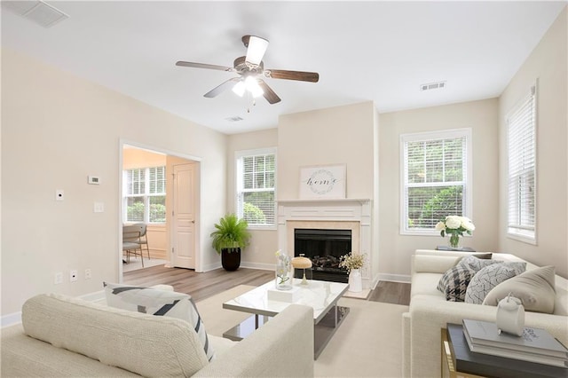 4130 Stonecypher Rd, Suwanee, GA 30024 - living room with plenty of natural light, a high end fireplace, wood finished floors, and ceiling fan