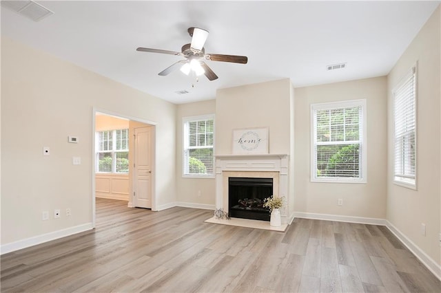 4130 Stonecypher Rd, Suwanee, GA 30024 - unfurnished living room with light wood finished floors, healthy amount of natural light, a premium fireplace, and ceiling fan