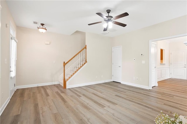 4130 Stonecypher Rd, Suwanee, GA 30024 - unfurnished living room featuring stairway, light wood-type flooring, and a ceiling fan