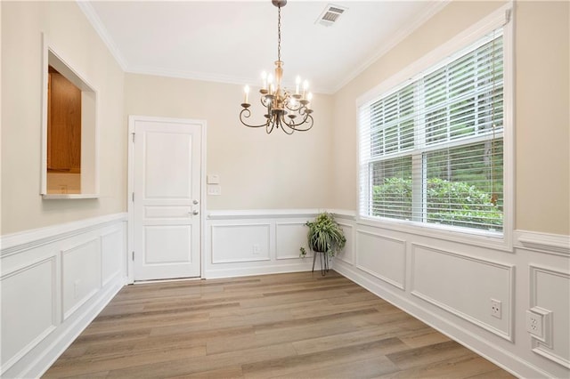 4130 Stonecypher Rd, Suwanee, GA 30024 - unfurnished dining area featuring a chandelier, crown molding, a wainscoted wall, a decorative wall, and light wood finished floors
