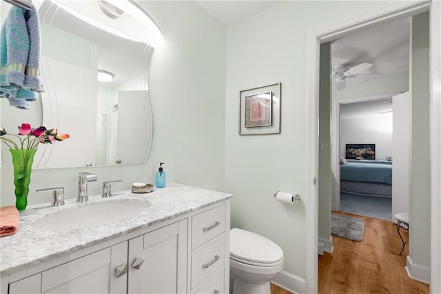 5180 Chemin De Vie, Atlanta, GA 30342 - ensuite bathroom featuring wood finished floors, toilet, a ceiling fan, vanity, and baseboards