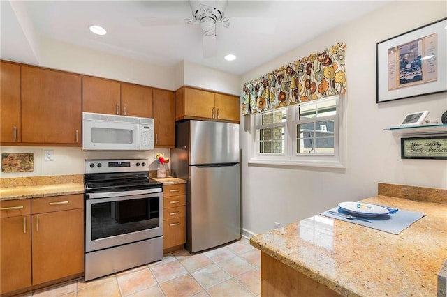 5180 Chemin De Vie, Atlanta, GA 30342 - kitchen featuring stainless steel appliances, ceiling fan, brown cabinets, light tile patterned floors, and recessed lighting