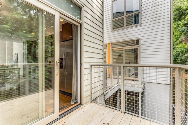 doorway to outside with wood-type flooring and wooden walls