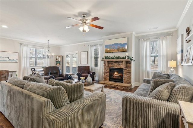 living room featuring crown molding, dark hardwood / wood-style flooring, and a stone fireplace