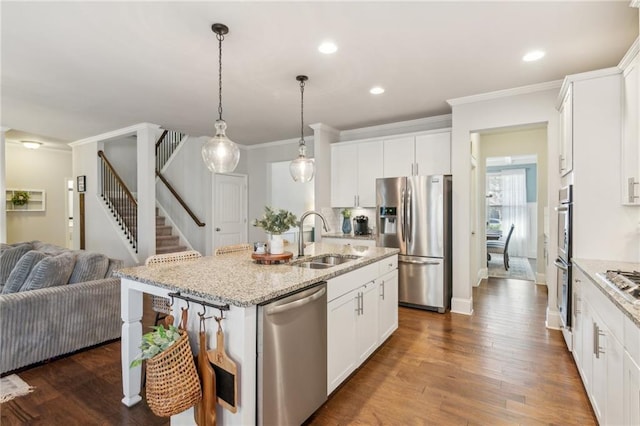 kitchen featuring white cabinetry, appliances with stainless steel finishes, sink, and a kitchen island with sink