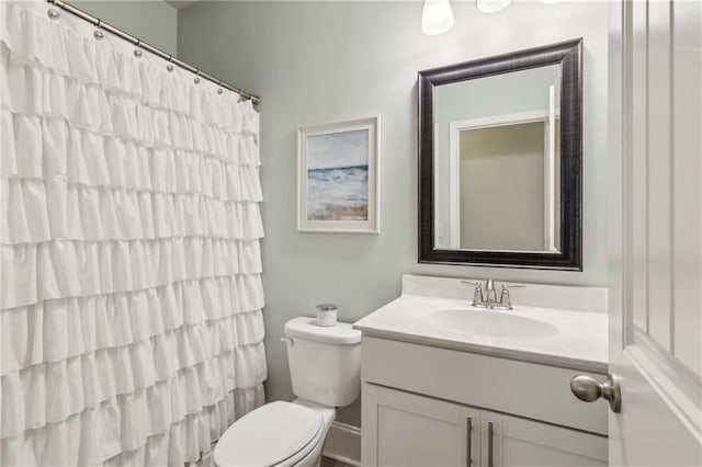 bathroom featuring vanity, toilet, and walk in shower