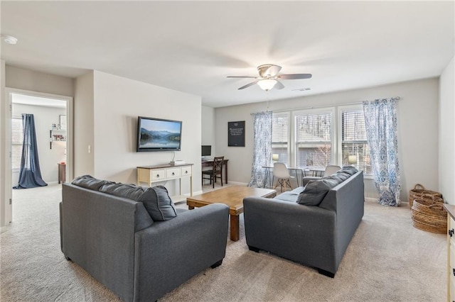 living room featuring light colored carpet and ceiling fan