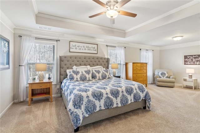 bedroom featuring crown molding, ceiling fan, a tray ceiling, and carpet floors