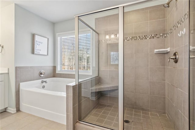 bathroom with tile patterned flooring, vanity, and shower with separate bathtub